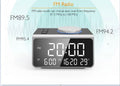 FM radio alarm clock with USB charging port and 3-inch digital display on a bedside table