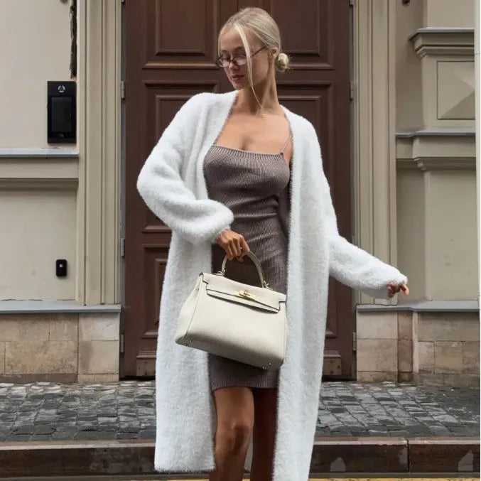 White longline knitted cardigan jacket for women, shown loose-fit with long sleeves.
