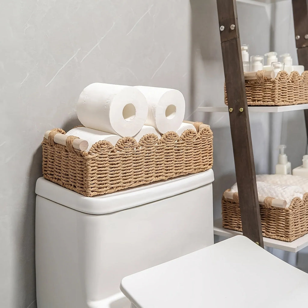 Modern minimalist woven paper storage basket on a desktop, holding remote controls and pens.