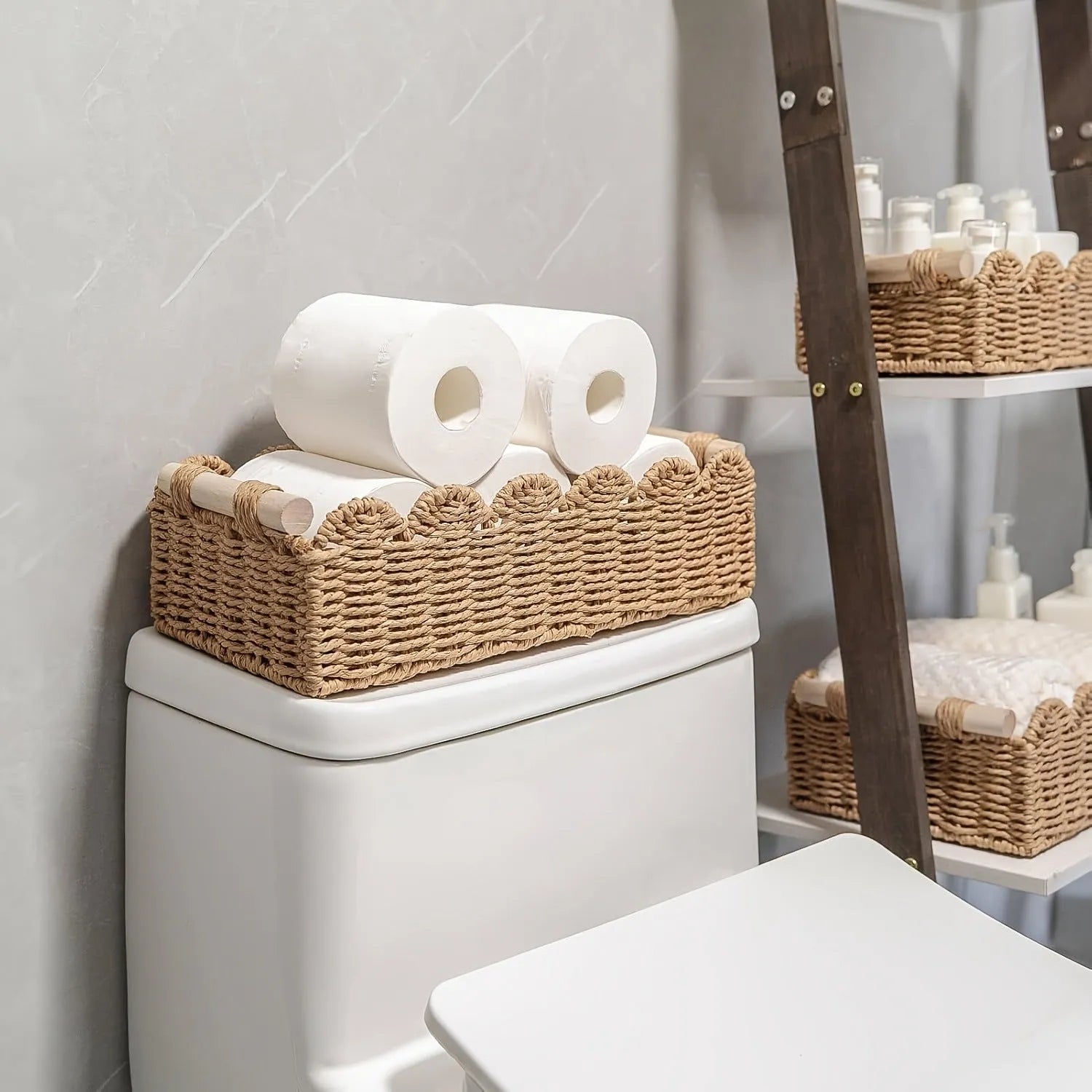 Modern minimalist woven paper storage basket on a desktop, holding remote controls and pens.