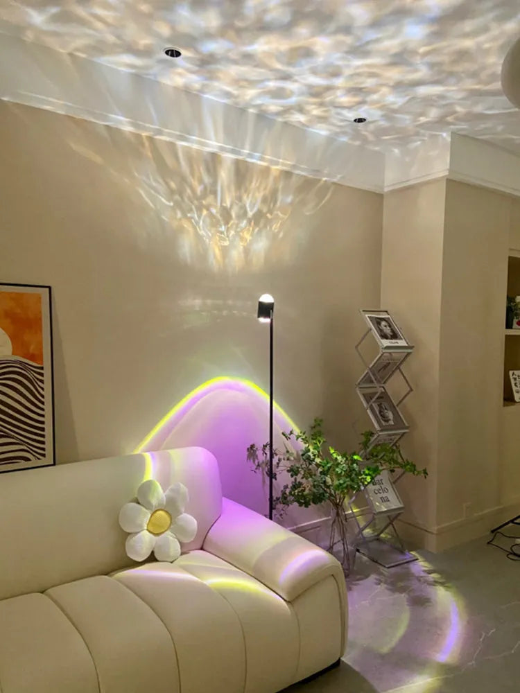 Modern water wave projection floor lamp in sunset red with four colour cards on a living room floor