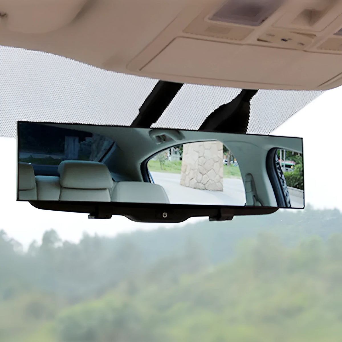 Black interior rearview mirror with double curvature glass, 300mm by 70mm, mounted on car windscreen