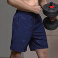 A pair of men's loose-fitting black sports shorts with an elasticated waistband, laid flat.