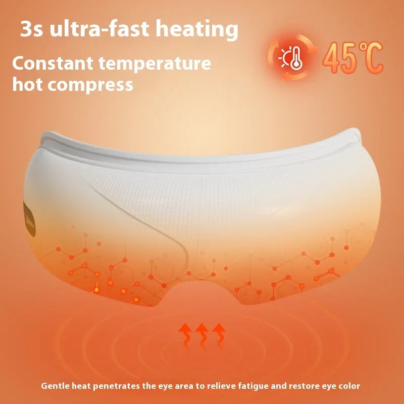White rechargeable eye massager with hot compress and airbag massage functions on a flat surface