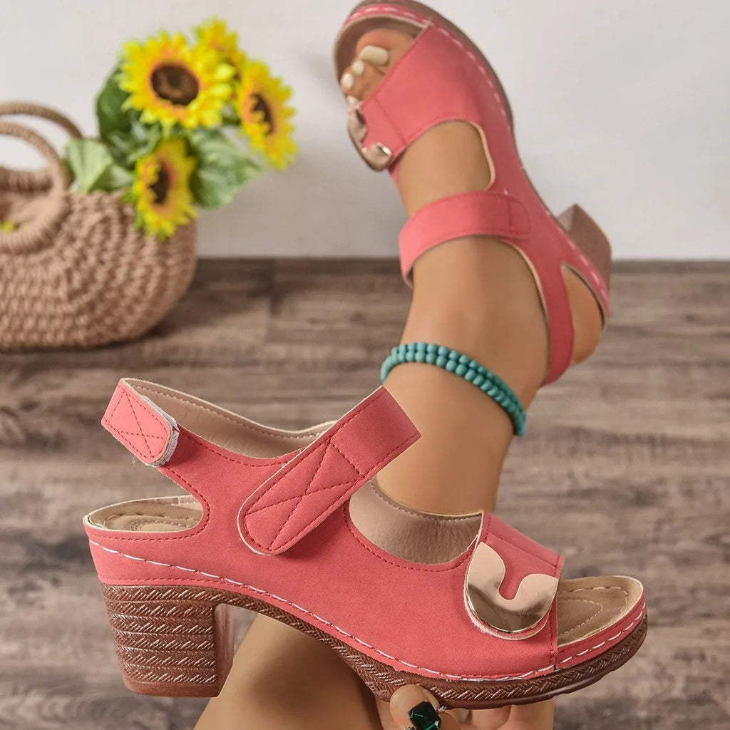 Light brown women's Roman sandals with a Velcro strap and rounded toe on a rubber sole.