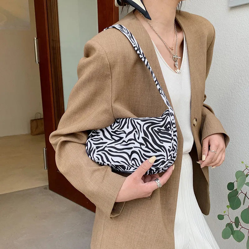 Women's small nylon underarm bag with leopard print pattern and zipper closure, 23cm size