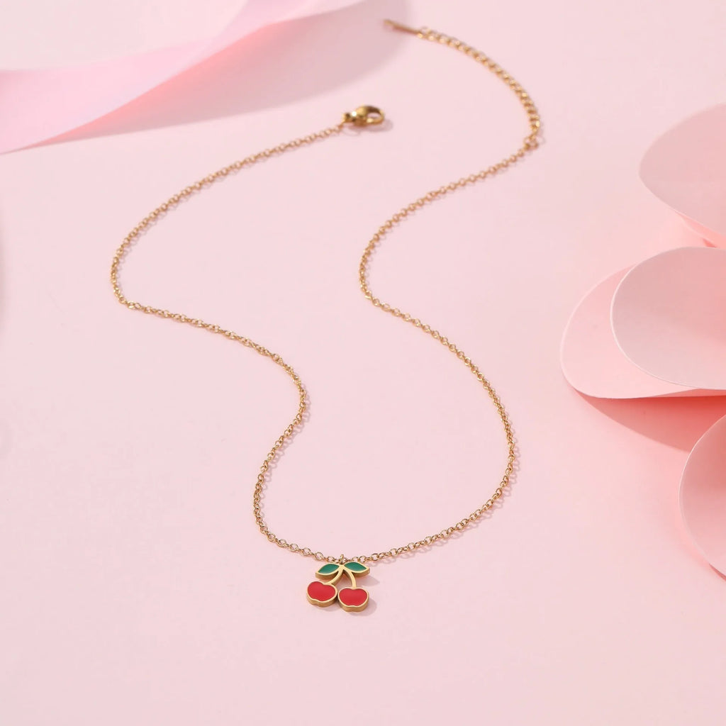 Complete cherry jewellery set showing stainless steel necklace, bracelet, earrings, and ring with 18K electroplating