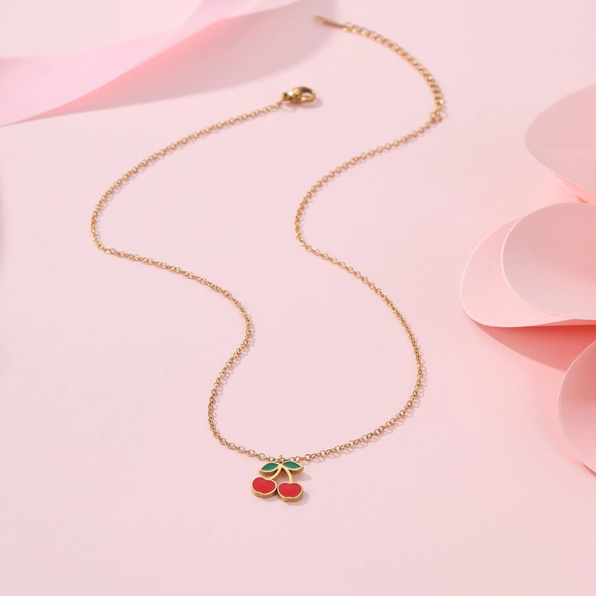 Complete cherry jewellery set showing stainless steel necklace, bracelet, earrings, and ring with 18K electroplating