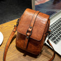 Women's retro crossbody phone bag in brown PU with square clamshell shape and single shoulder strap