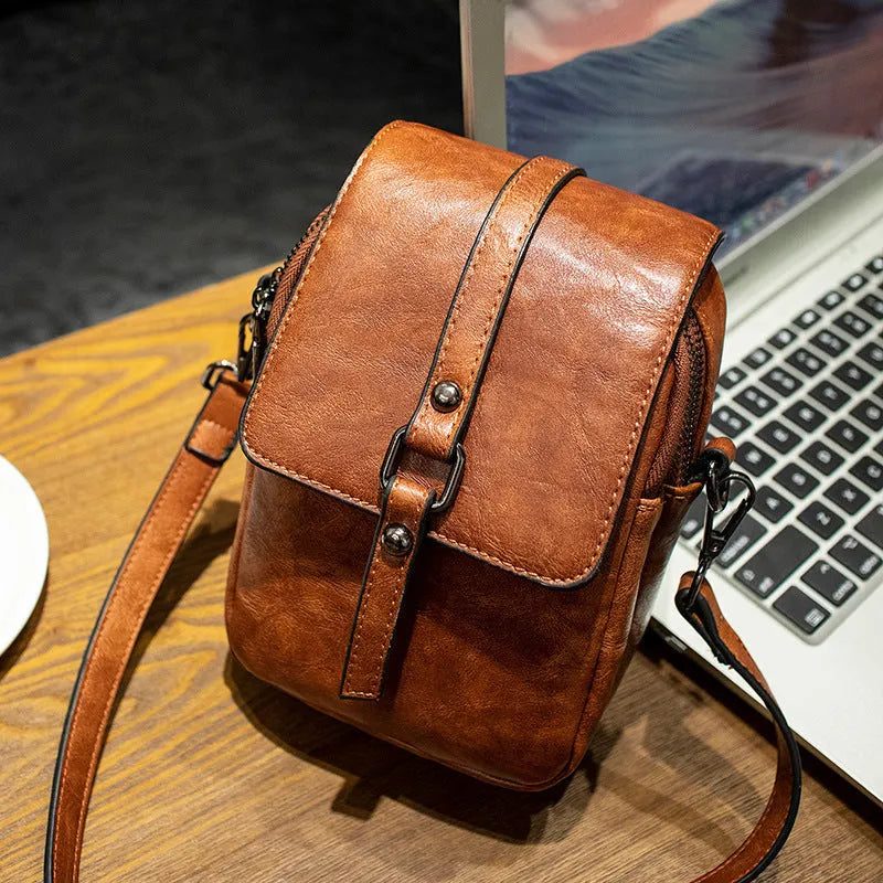 Women's retro crossbody phone bag in brown PU with square clamshell shape and single shoulder strap