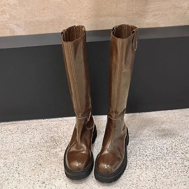 Women's black chunky heel knight boots with round toe and back zipper showing side profile