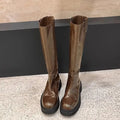 Women's black chunky heel knight boots with round toe and back zipper showing side profile