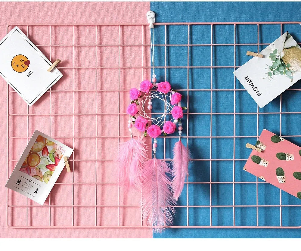 Close-up of a modern pink ostrich feather dreamcatcher wind chime wall ornament.