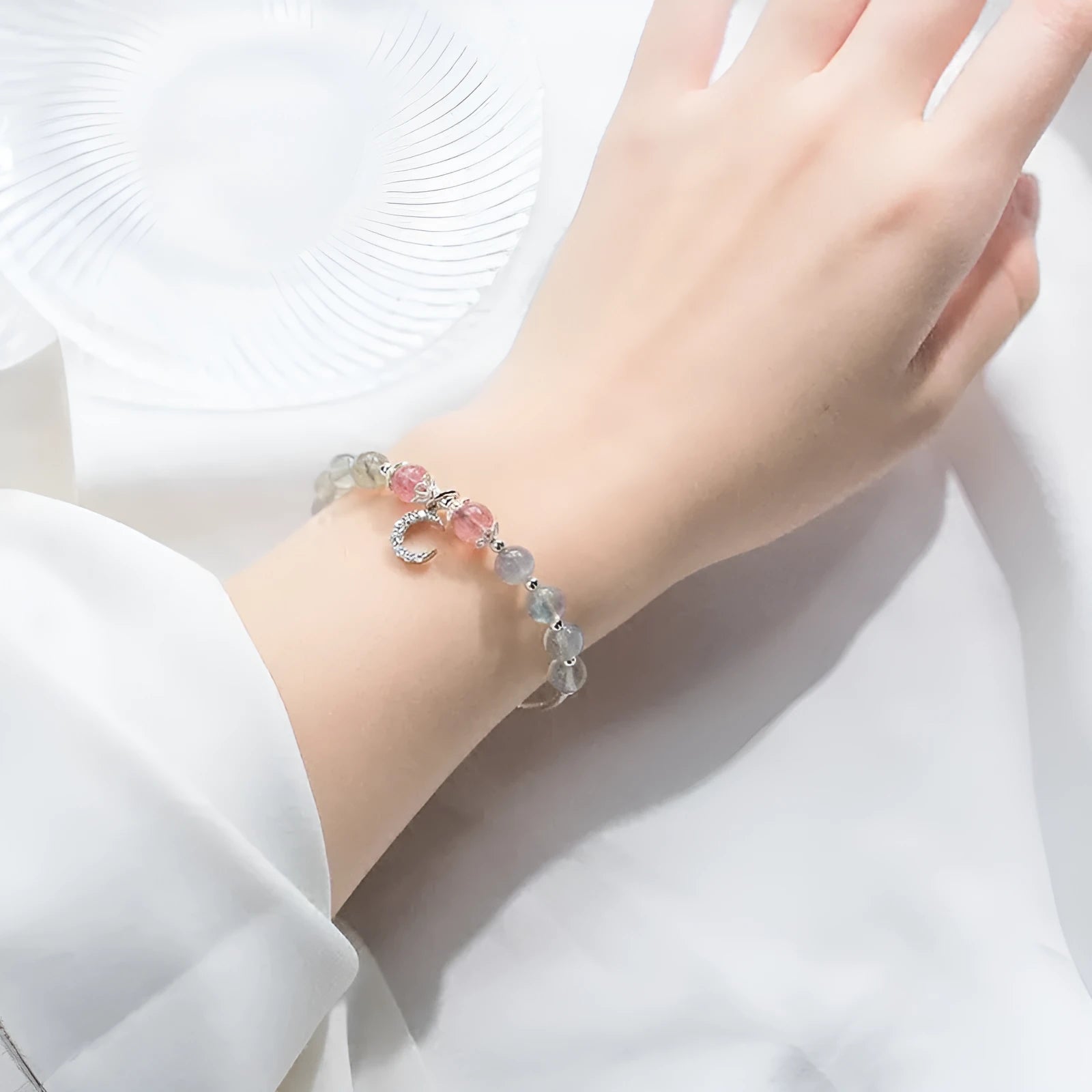 Handmade adjustable moonstone bracelet with 6mm stone and crescent moon charm on silver chain