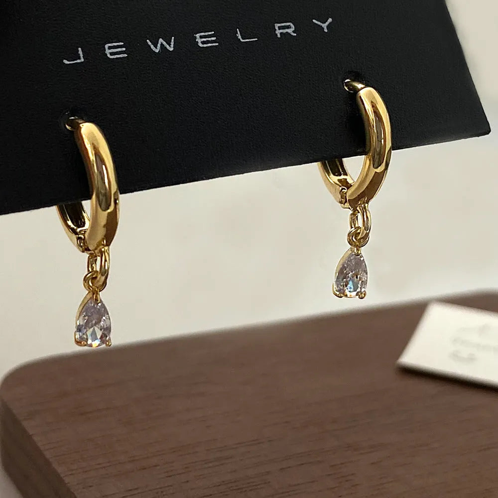Zircon jewellery set with geometric necklace, matching earrings, and anklet.