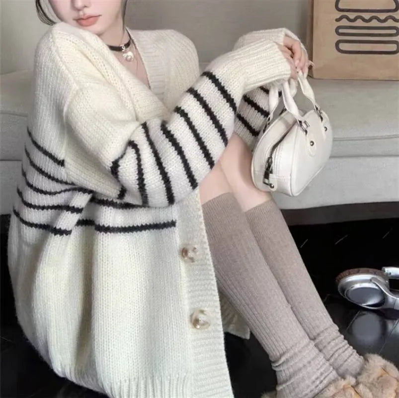 Polyester cardigan sweater with 3D pattern, button front, and stand-up collar in a free size.
