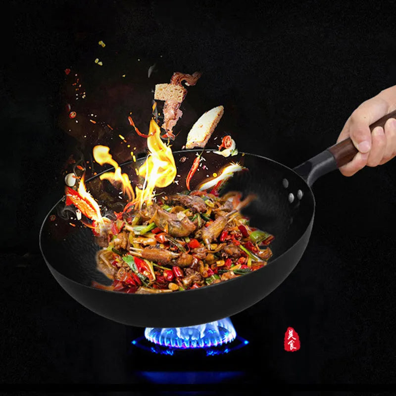 Traditional black iron wok with a long wooden handle, shown with a glass lid.