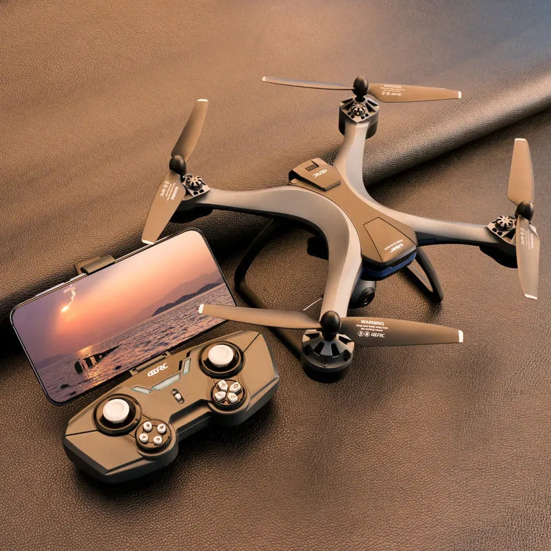 GPS remote control quadrocopter aircraft with dual cameras, spare blades, and handle controller on a table.