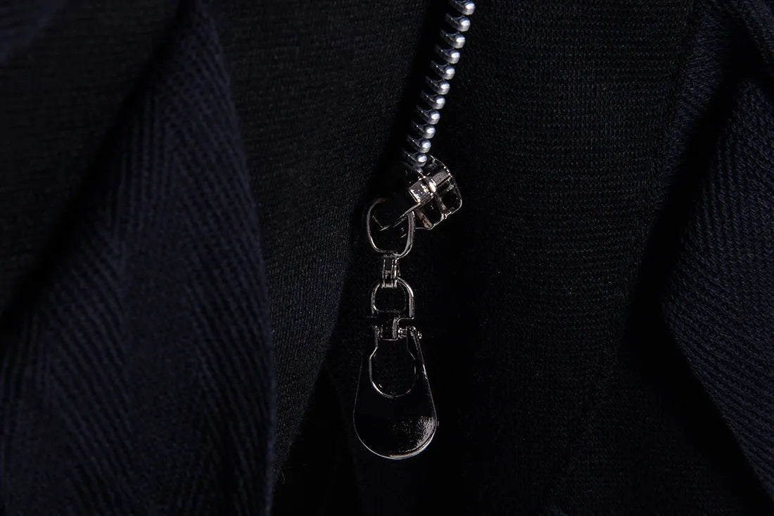Men's black low crotch cross trousers with tapered cone leg and small hem on a plain background