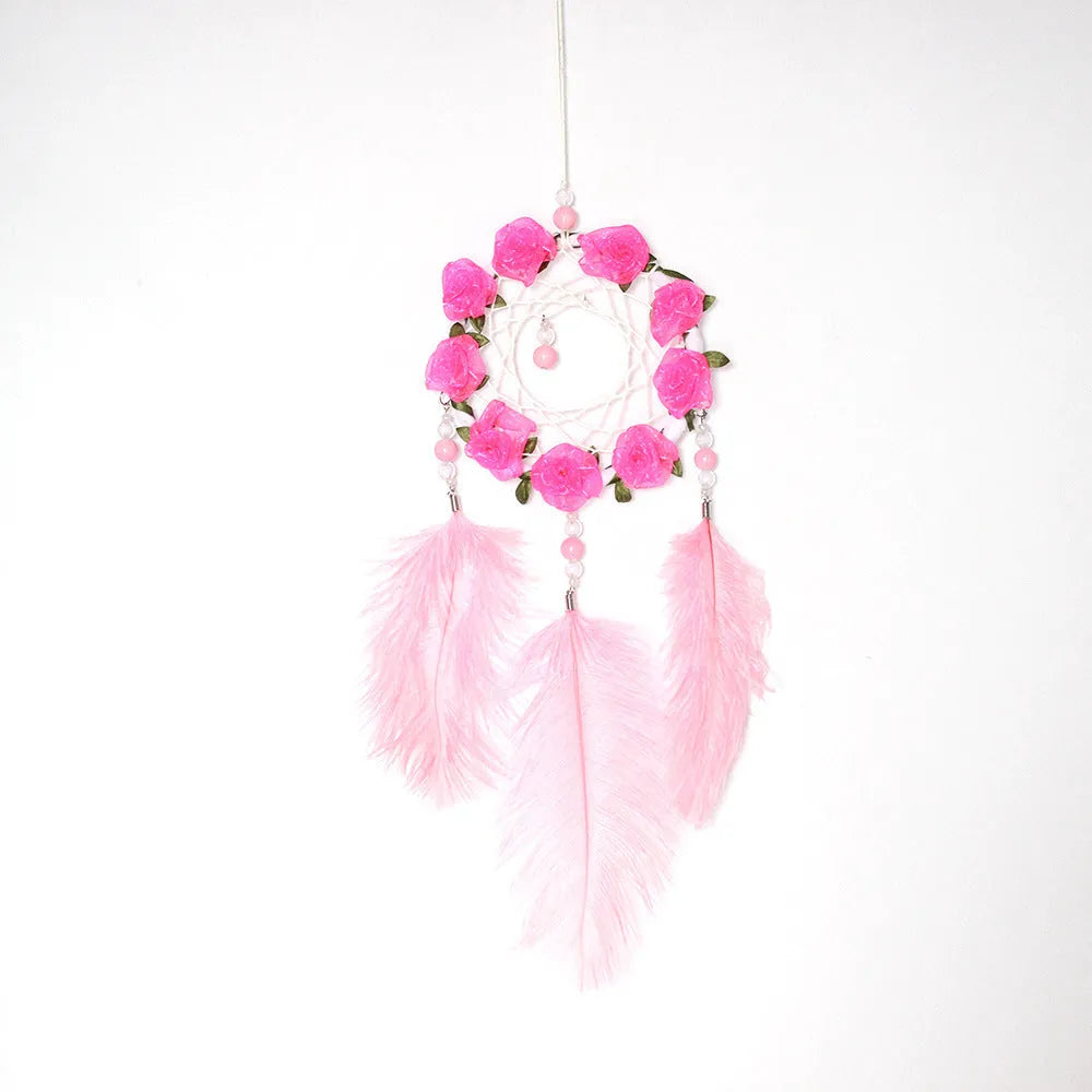 Close-up of a modern pink ostrich feather dreamcatcher wind chime wall ornament.