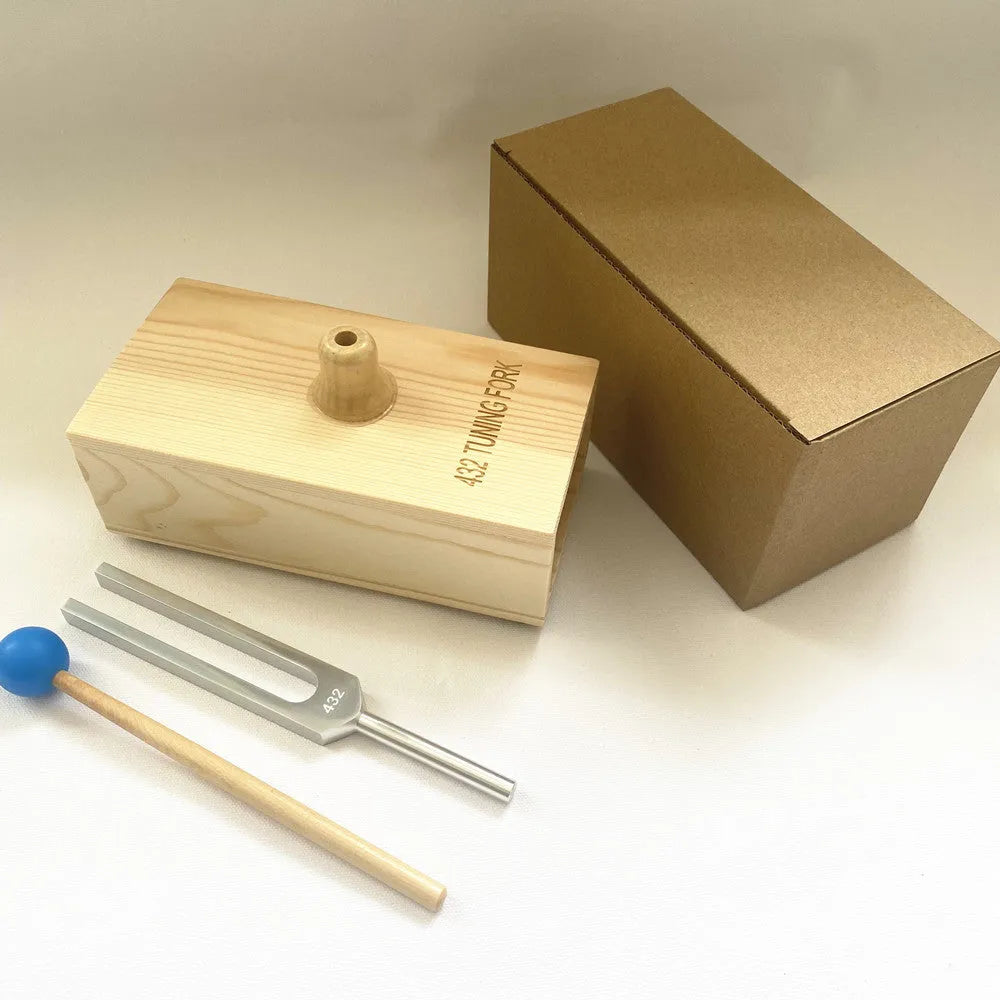 Aluminium alloy 432Hz tuning fork with a separate speaker unit on a kraft paper box.