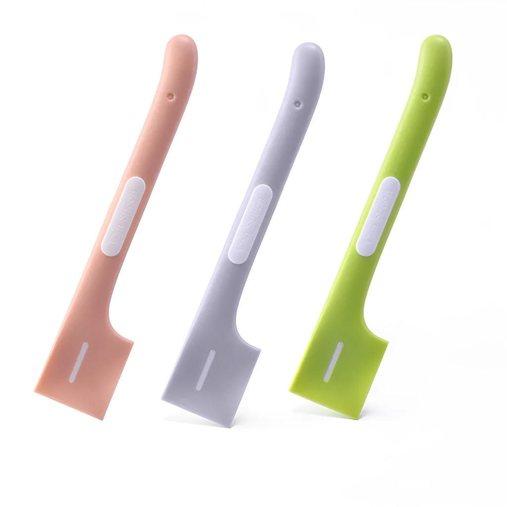 Green long-handled pet food spoon with angled head for scooping canned cat or dog food.
