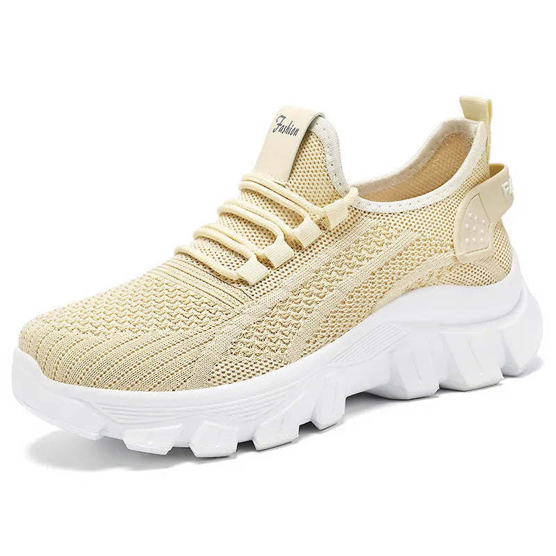Women's Flyknit sneakers with thick PVC sole in beige colour showing lace-up front and round toe design