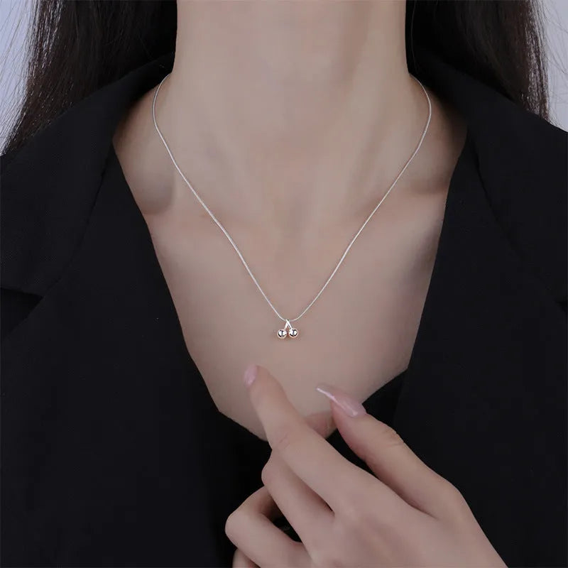 Silver cherry pendant necklace for women with adjustable snake chain.