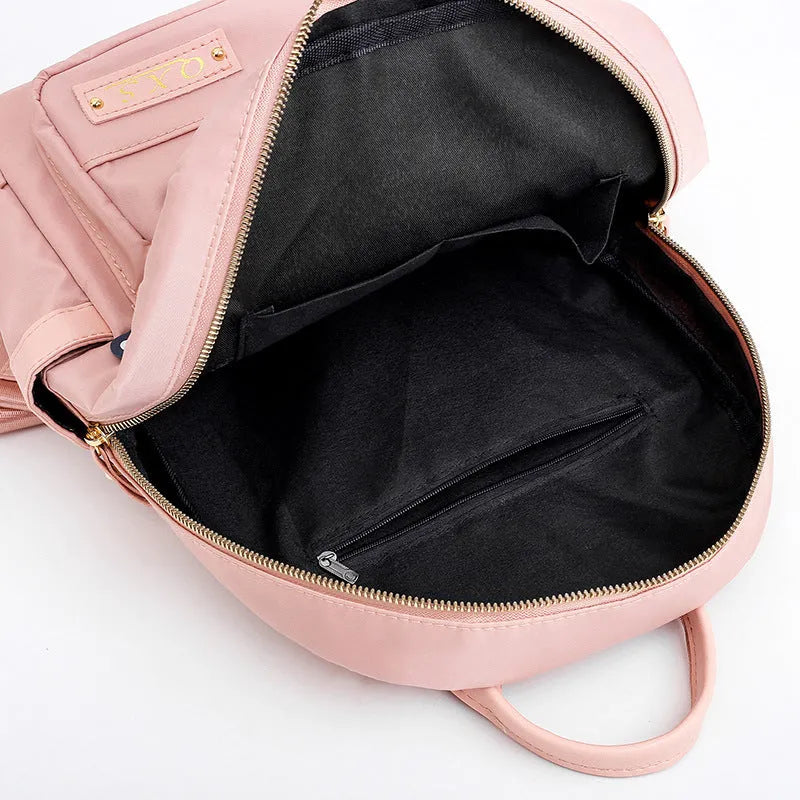 Soft black nylon women's casual backpack with double straps, external pocket, and internal organisers.