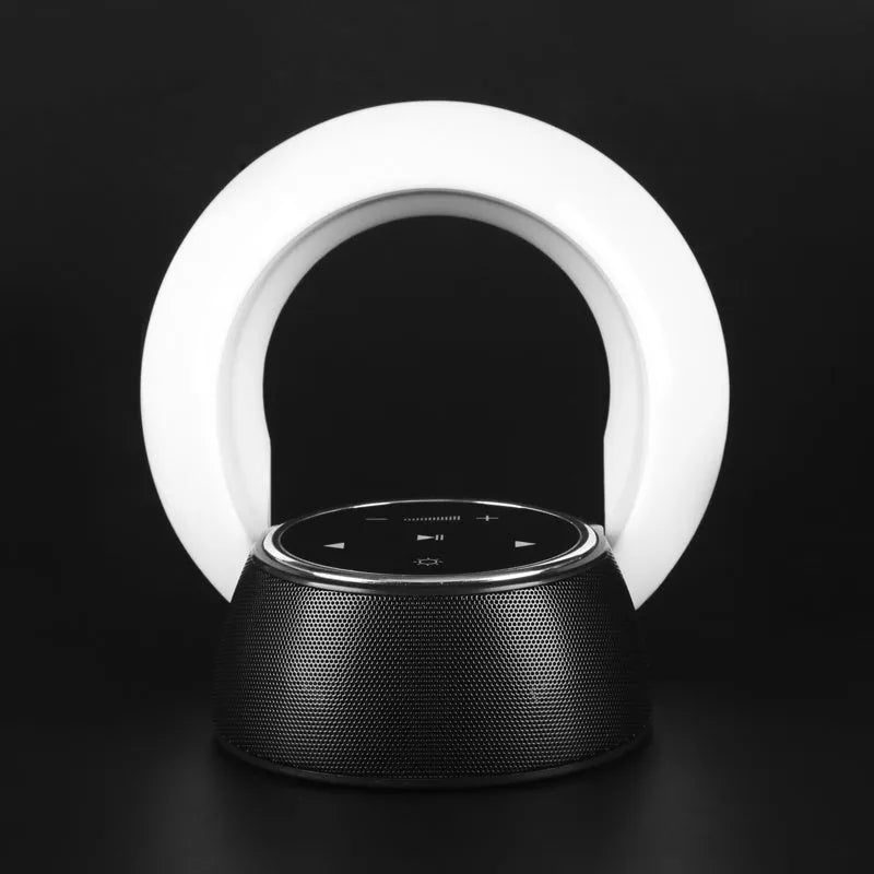 Folding Bluetooth desk lamp and speaker with touch controls showing blue atmospheric LED light.