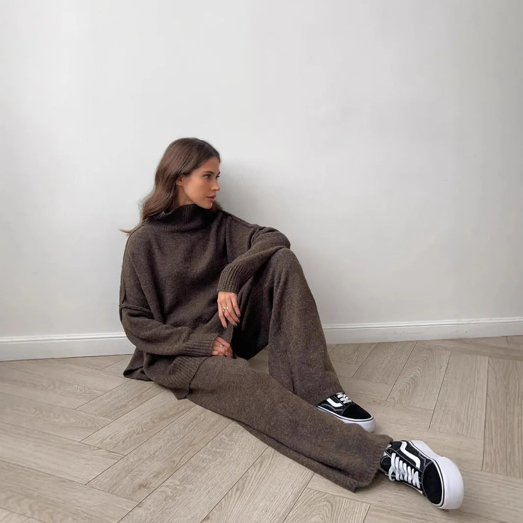 Dark grey women's knitted side-slit top and matching trousers set on a hanger