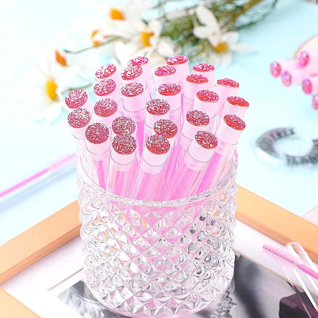 Disposable mascara brushes in transparent storage tubes for eyelash extensions and makeup.