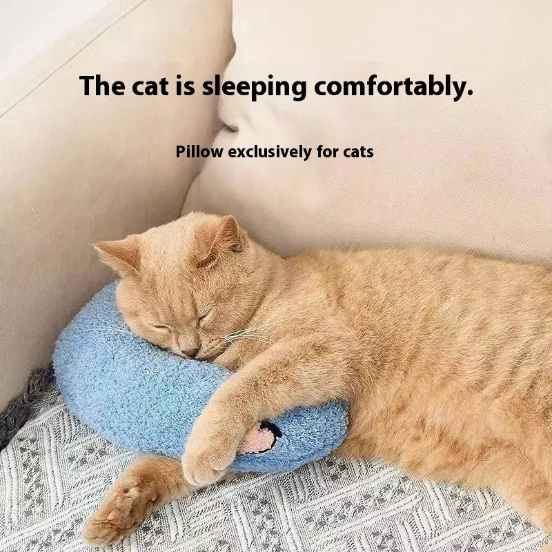 Blue U-shaped cat pillow with neck support in a moon design on a wooden floor.