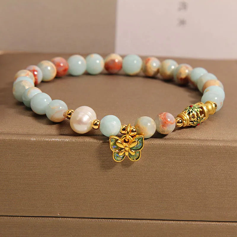 Blue women's bracelet with Shoushan Stone and freshwater pearl butterfly design featuring adjustable closure