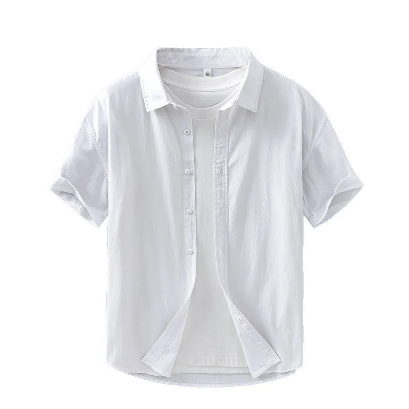 Man wearing a loose fit, light grey short-sleeved cotton shirt in a casual cardigan style.