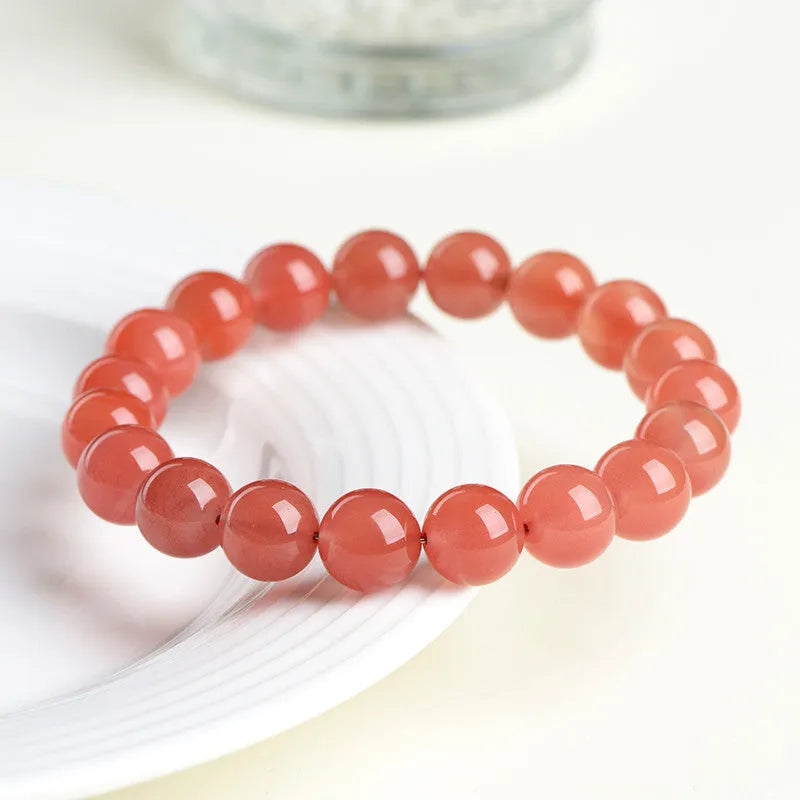 Natural South Red Cherry Agate scattered bead bracelet showing polished gemstone beads on a wrist.