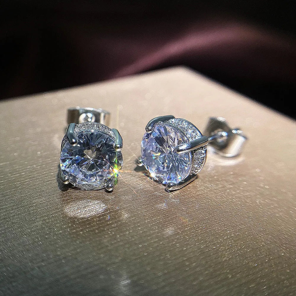 Women's round white zircon stud earrings with copper geometric round shape on display