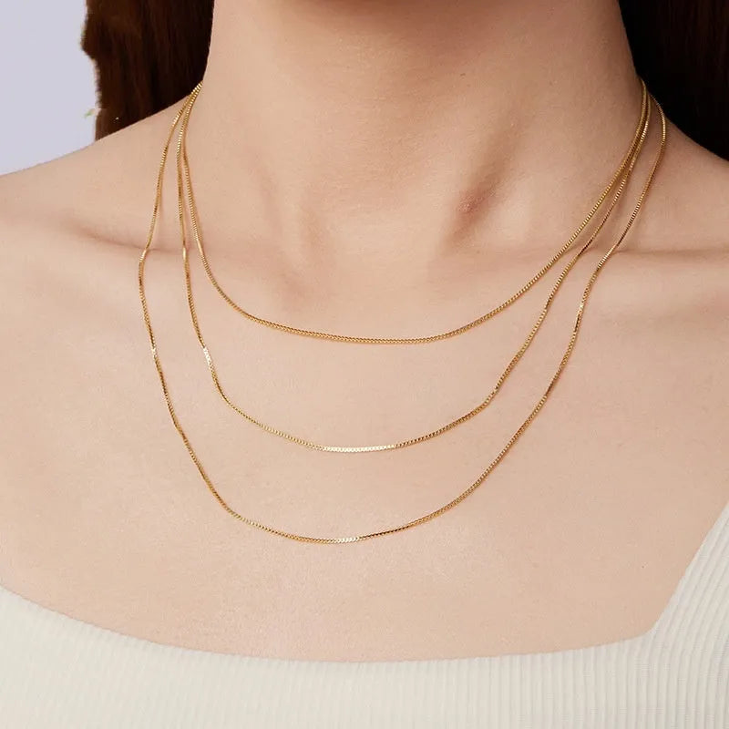 S925 sterling silver box chain necklace in silver colour, 40cm length on flat surface