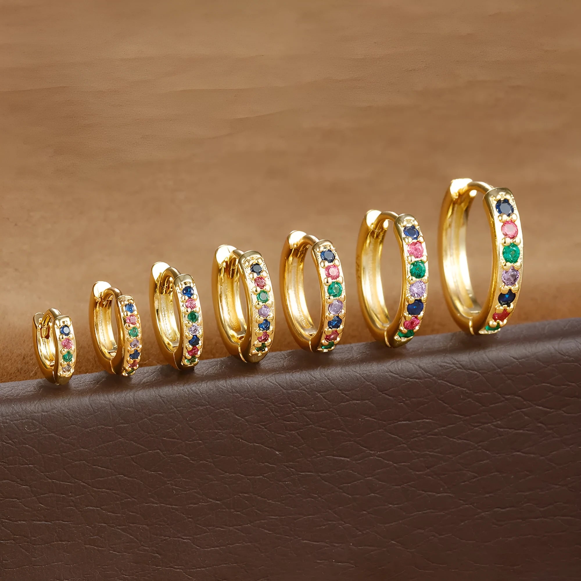 Gold, rose gold, and silver coloured perforated circle zircon stud earrings in various sizes from 5mm to 12mm diameter.