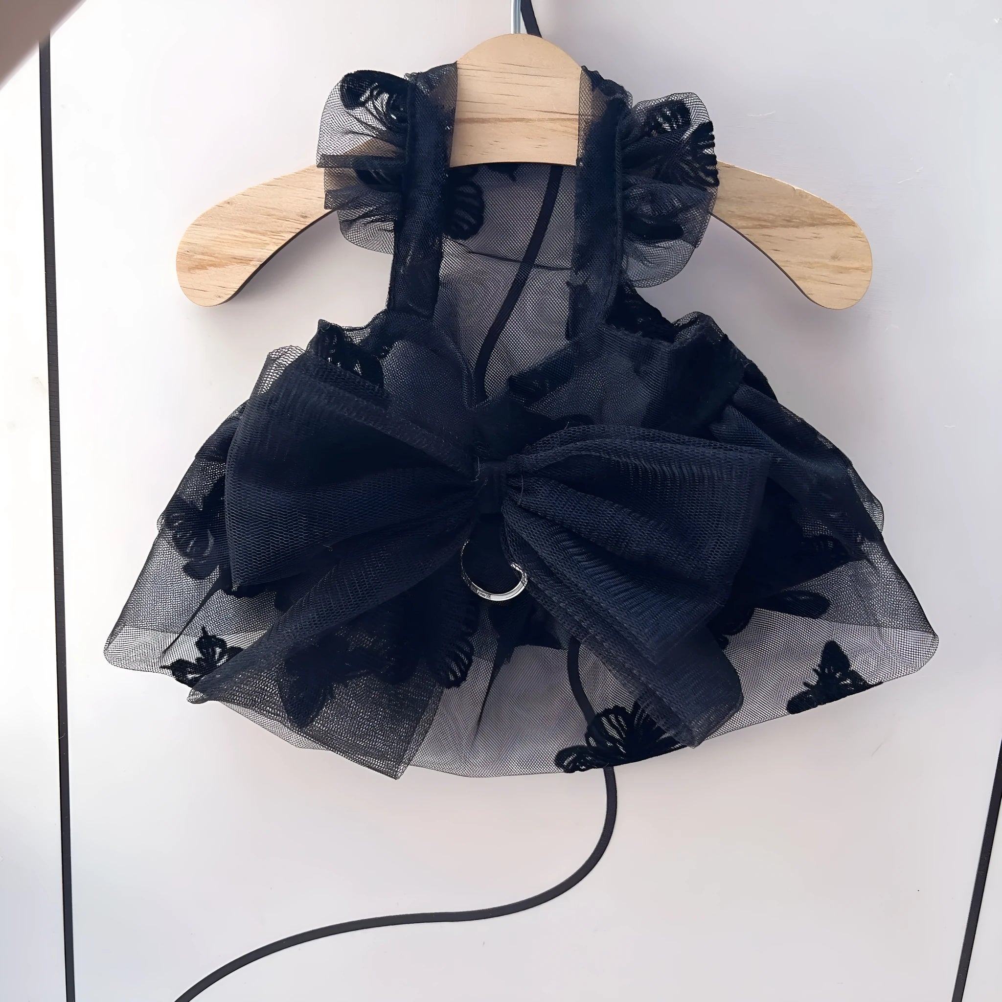 Black tiered tulle princess skirt on a small dog, showing the gauze layers and fit.