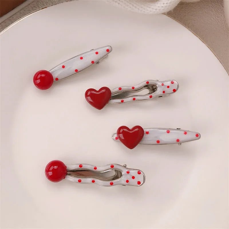 Red stereo love heart-shaped hairpin with French retro dots and willow leaf decoration on a white background.