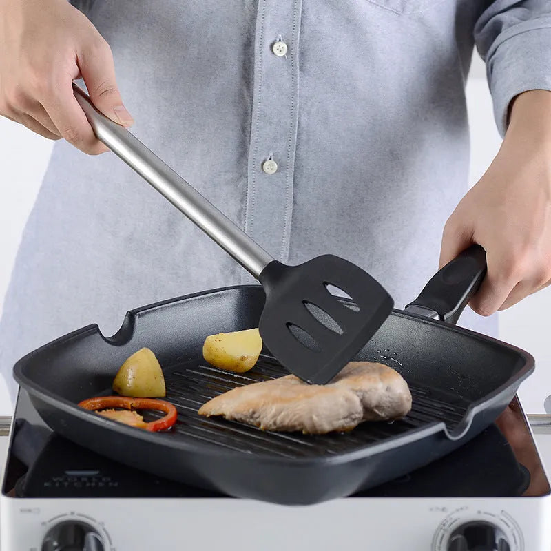 Black silicone kitchen utensil set with stainless steel handles including spatulas and spoons