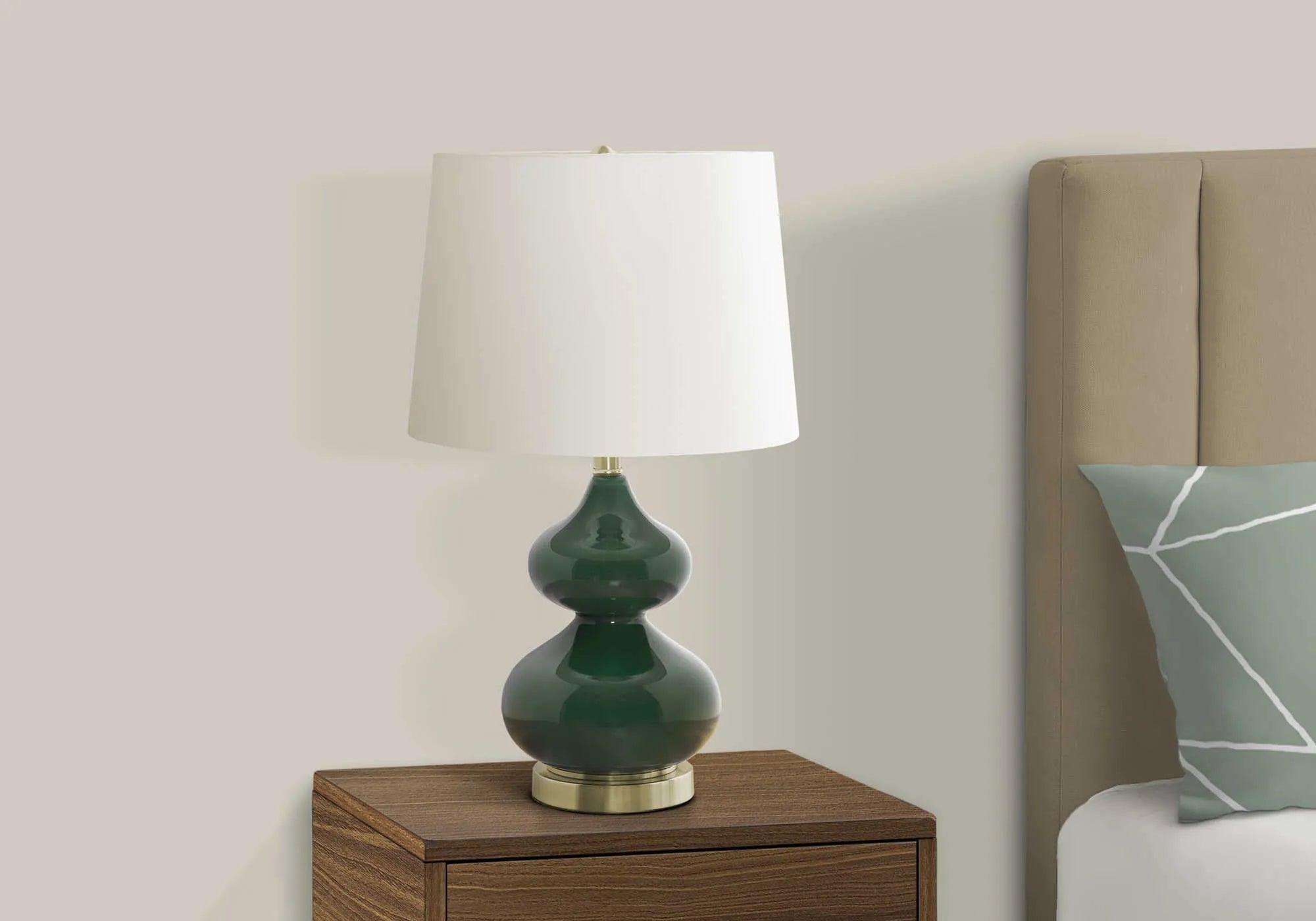 Blue cloth shade desk lamp with a clear crystal glass base on a wooden desk.