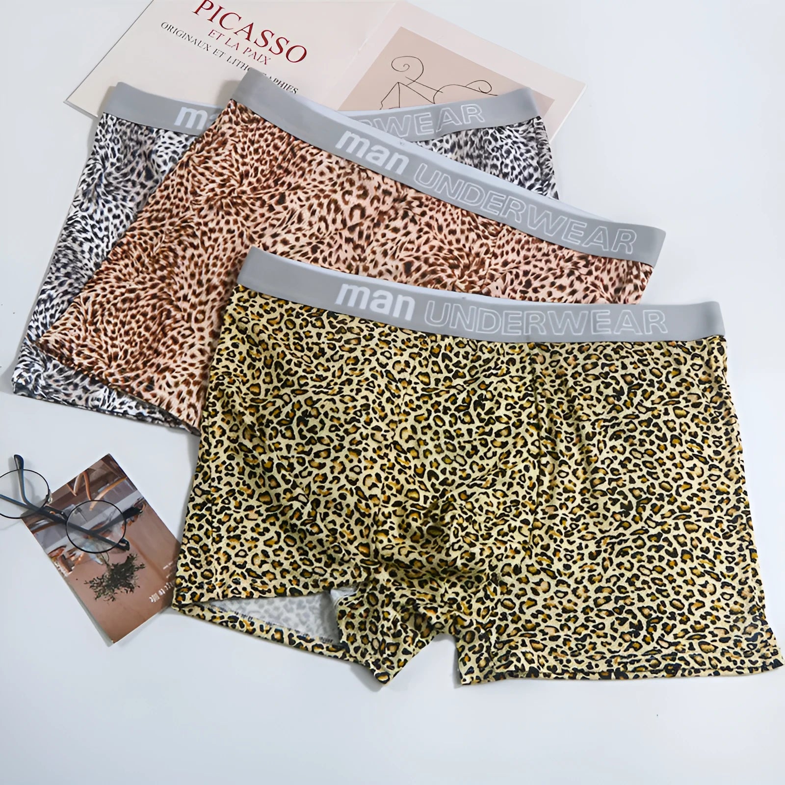 Men's loose fit leopard print boxer shorts in polyester milk silk fabric showing mid-waist design