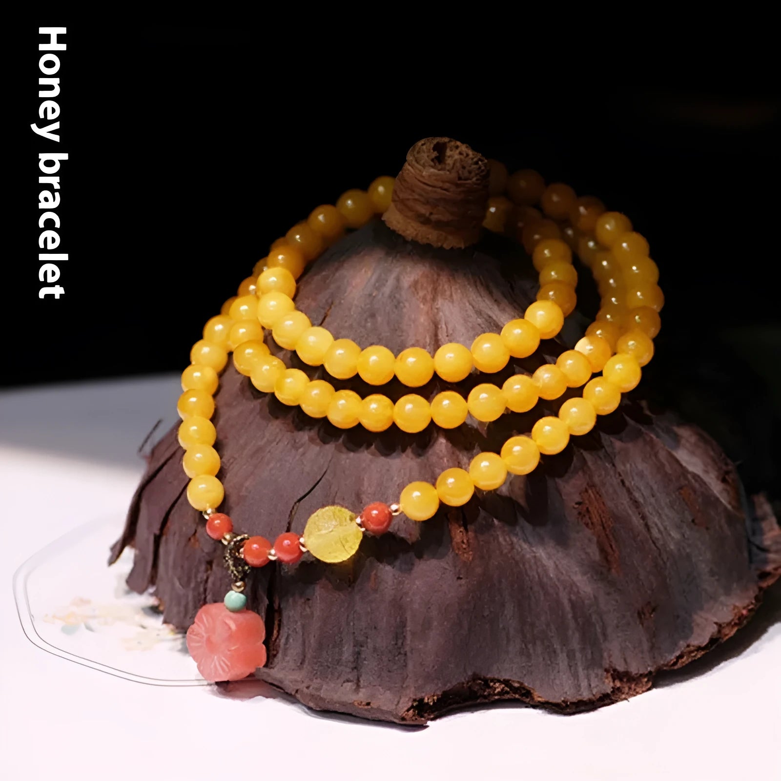 Yellow amber bracelet with 5mm round beads and animal zodiac design on wrist