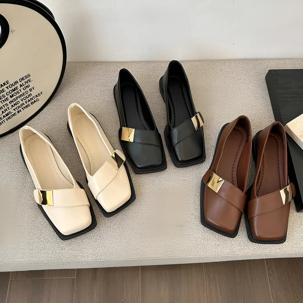 Beige women's square-toe flat shoes with a metal buckle and low rubber sole.
