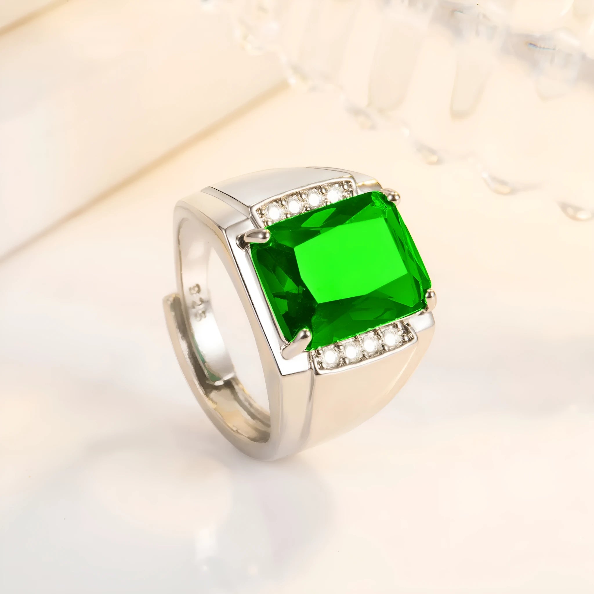 Adjustable geometric copper ring with a choice of coloured synthetic rhinestones on a white background.
