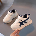 Children's white casual sneaker with Velcro strap and rubber sole, shown in sizes 21-30.