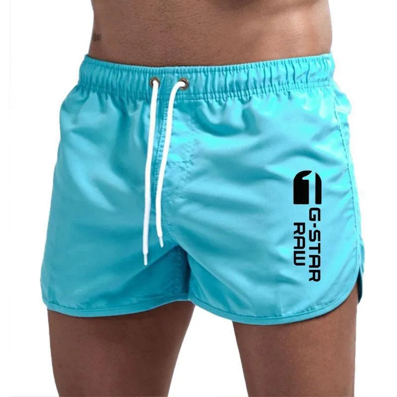 Men's thin polyester sports shorts in various colours with an elasticated waistband.