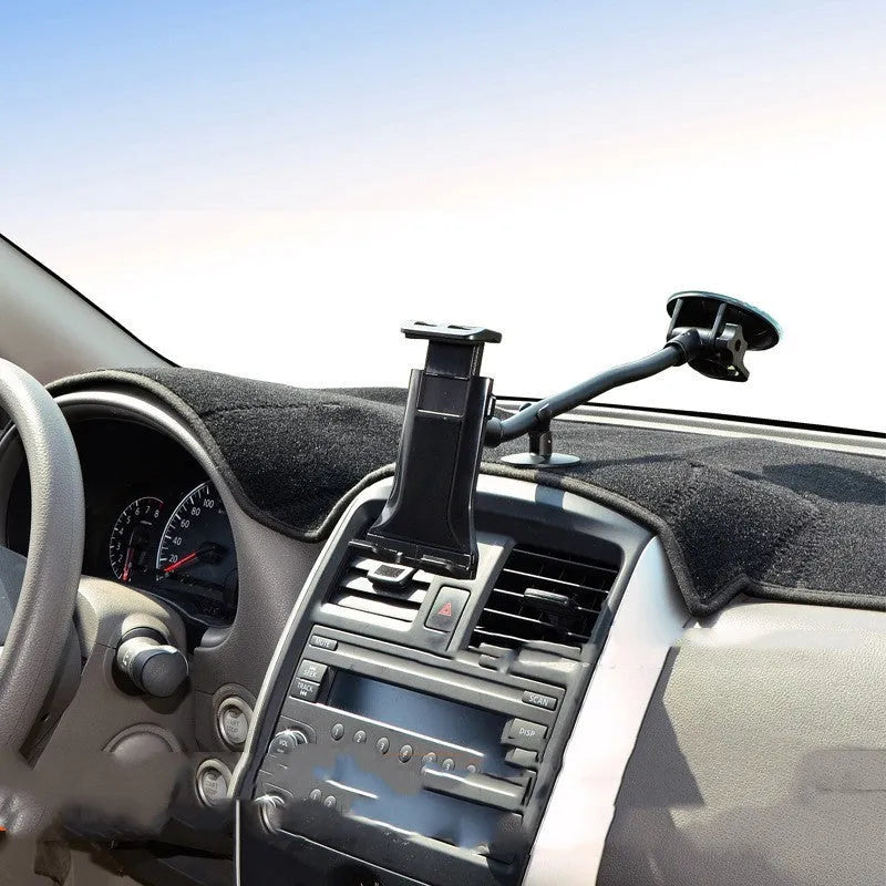 Black universal vehicle-mounted tablet and phone holder with suction cup on a car dashboard